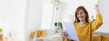 excited young woman holding paper letter
